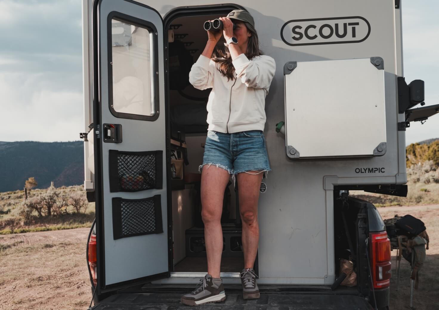 Shop Forsake women's featuring a woman on the back of a camper.
