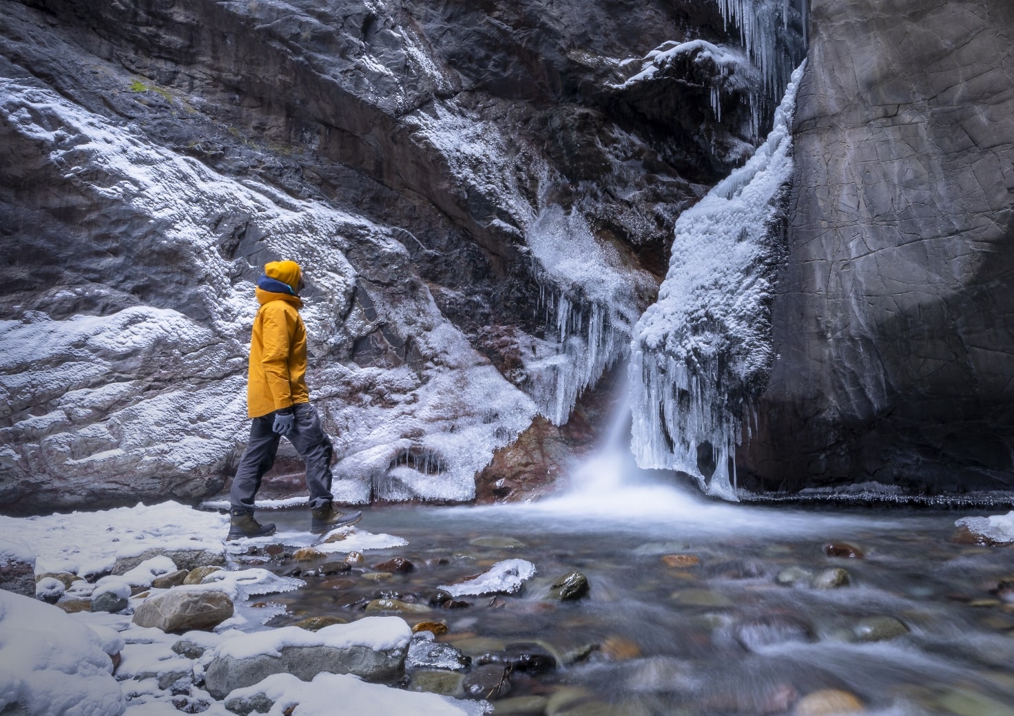 Shop Forsake men's featuring a man by a waterfall with a dusting of snow.