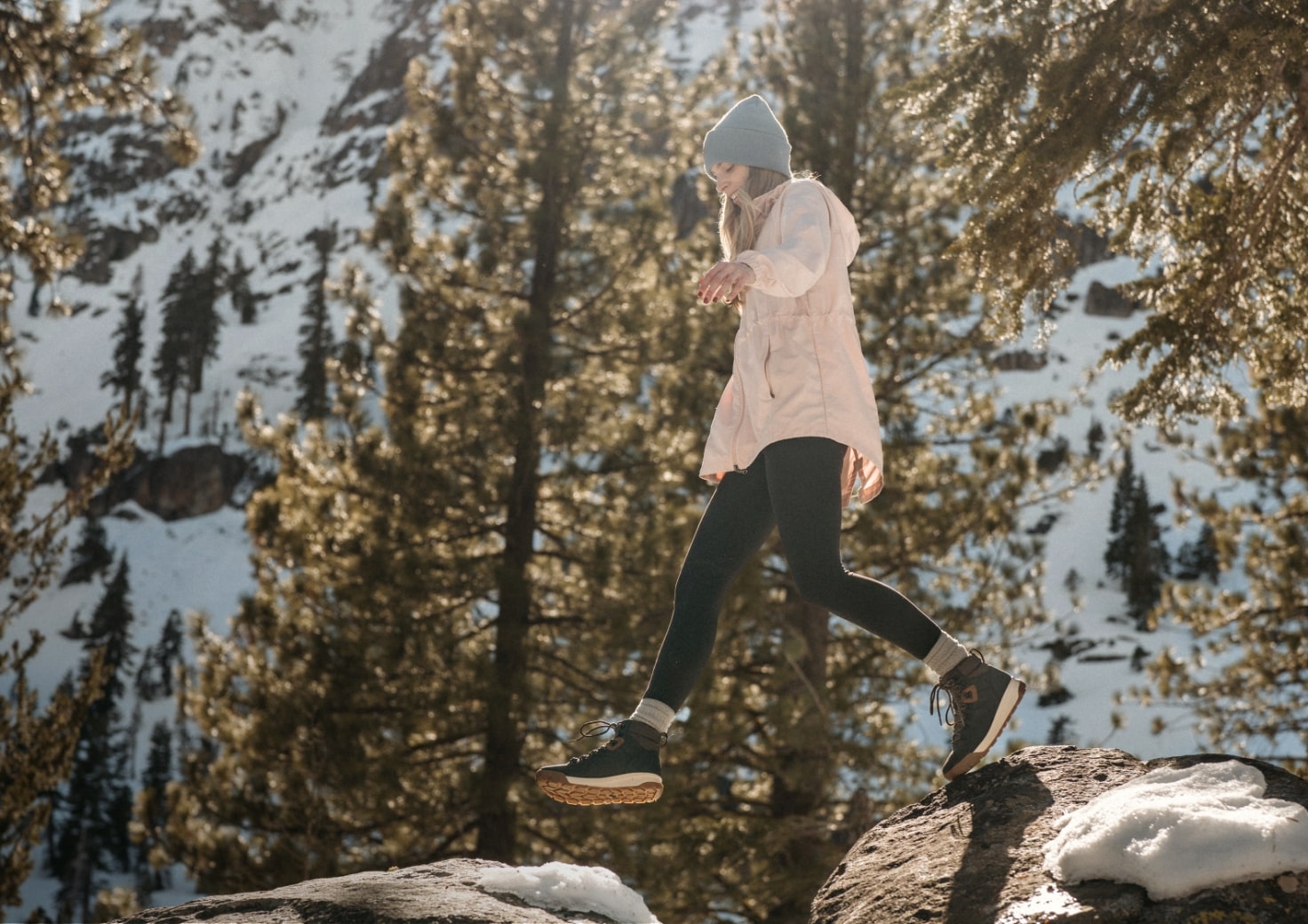 Shop Forsake women's featuring a woman on snowy rocks.