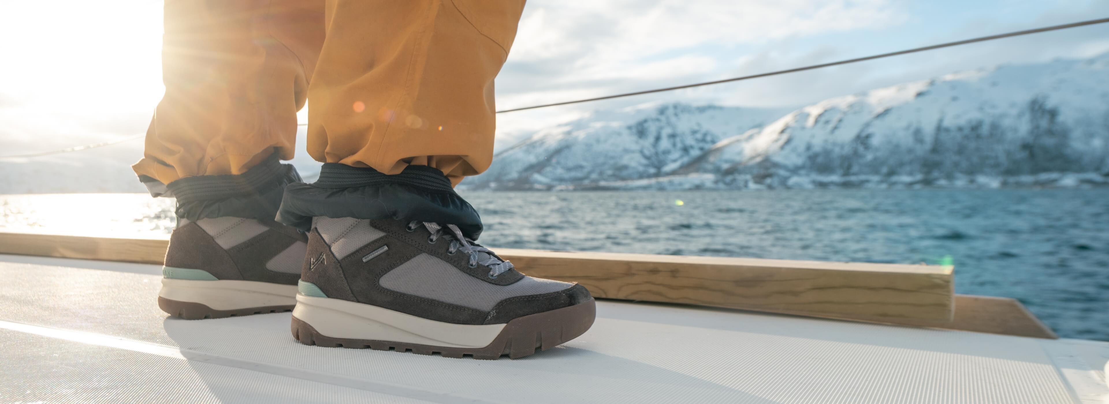 Shop Forsake's Men's and Women's Best Sellers featuring the Fifteen Mid Waterproof Sneaker Boot in Raisin on a snowy landscape.